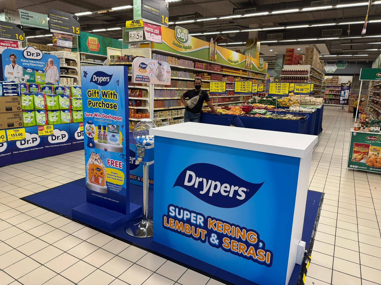 Drypers gift-with-purchase activation booth in a supermarket aisle