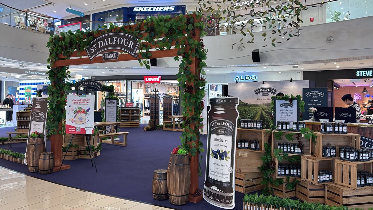 St Dalfour France-to-Table premium roadshow arch draped in vines with wine barrels